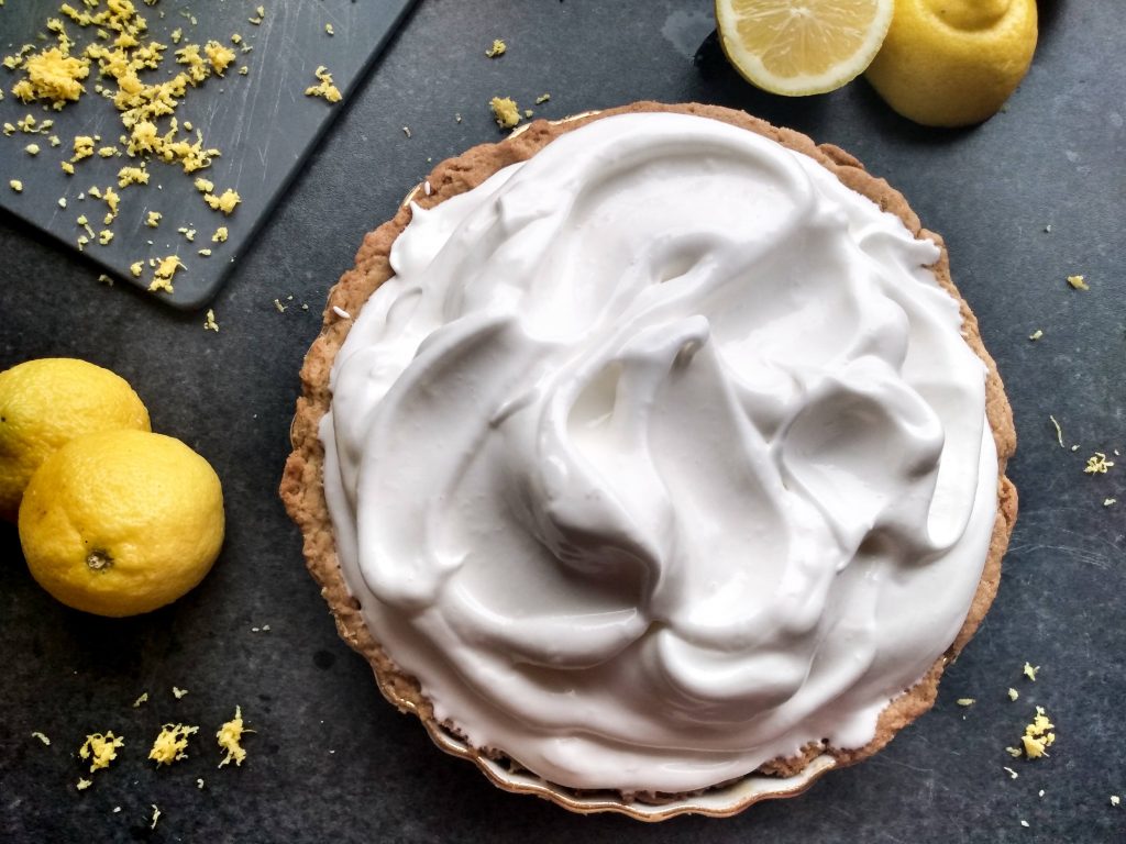 Unbaked meringue on top of pie crust and lemon filling. No-fail lemon meringue pie recipe by a Hopeful Home.